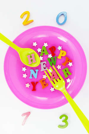 Colorful character Happy New Year greetings in plastic dishes の写真素材