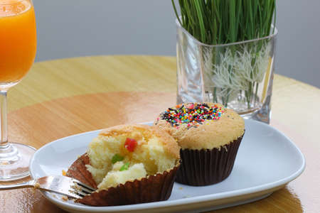 Thai cup cake with fork and Orange juiceの写真素材