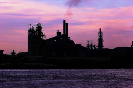 Factory smoke emission river evening の写真素材