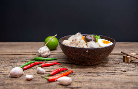 Chinese homemade pork soup noodle with egg, mushroom, pork balls, chilli, garlic , very yummy, soft focus.の写真素材