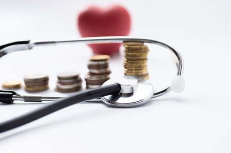 A dollar bill and stethoscope with syringe is inserted into the bill. The concept is the fall of the economy. Inflation, covid-19 pandemicの写真素材