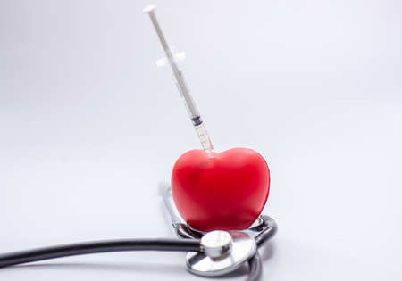 Red heart with syringe and stethoscope, checkup heartの写真素材