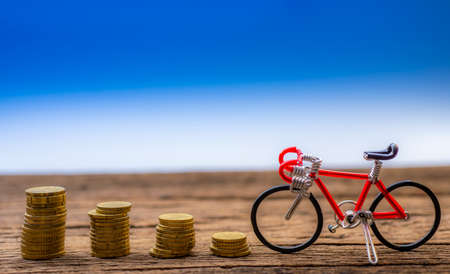 Bike and coins on business saving and investment conceptの写真素材