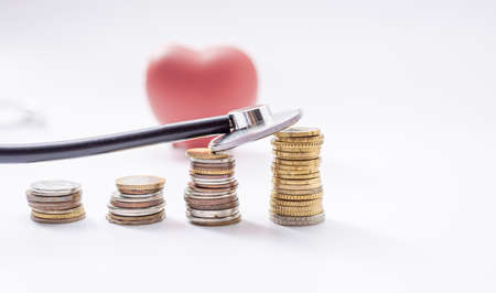 Red heart with coins and stethoscope, cost of checkup healthy concept ,COVID-19の写真素材