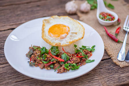 Thai Food Rice topped with egg and stir-fried beef and basil, famous street food in Thailand, fast food, soft focusの写真素材