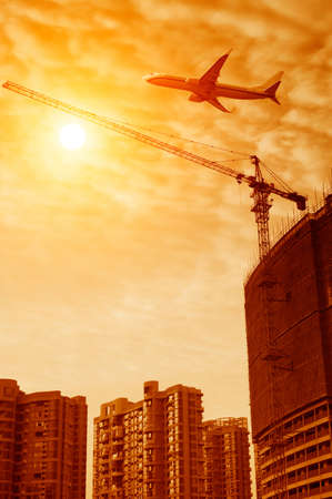 Sunset on the construction site tower crane workの写真素材