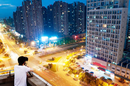 The keen photographer on a roof of the house の写真素材