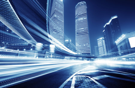the light trails on the modern building background in shanghai china. 