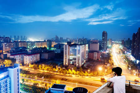 The keen photographer on a roof of the house の写真素材