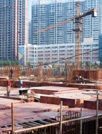 building under construction with workersのeditorial素材