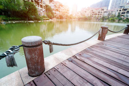 platform beside lake with sunset in parkの写真素材