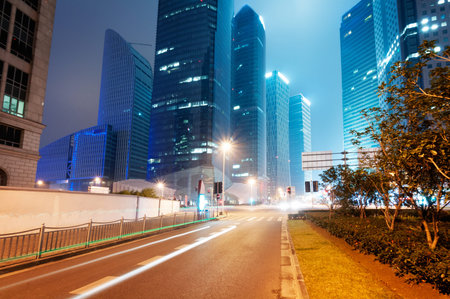 the light trails on the modern building background in shanghai china. の写真素材