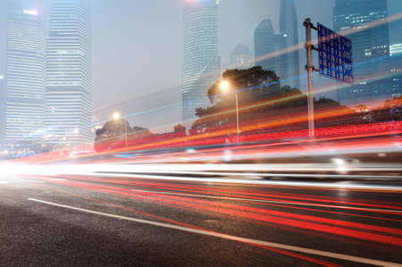 moving car with blur light through city at nightの写真素材