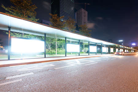 Blank billboard on bus stop at night の写真素材