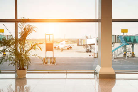 Airport, A huge viewing glass facade with a passenger aircraft behind it.のeditorial素材