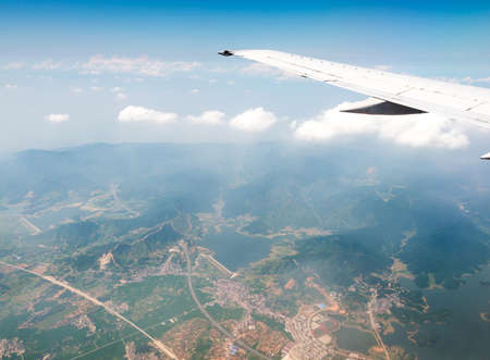 Wing aircraft in altitude during flightの写真素材