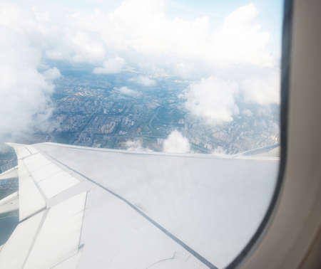 Clouds and sky as seen through window of an aircraftの写真素材