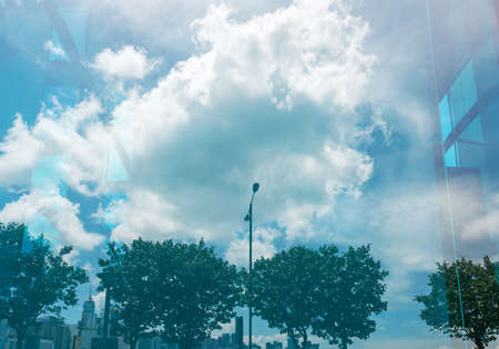 Clouds reflected in windows of modern office buildingの写真素材