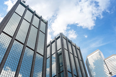 Clouds reflected in windows of modern office building