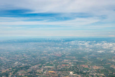 Aerial view from airplane on ground with fields, forest and riversの写真素材