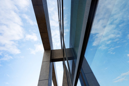 Clouds reflected in windows of modern office building