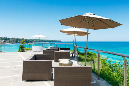 Beach chairs on the white sand beach with cloudy blue skyのeditorial素材