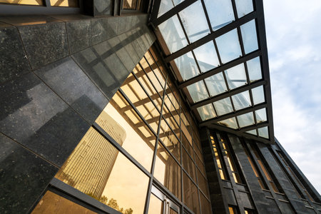Clouds reflected in windows of modern office building
