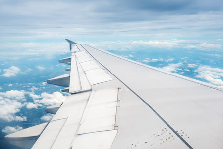 Clouds and sky as seen through window of an aircraft