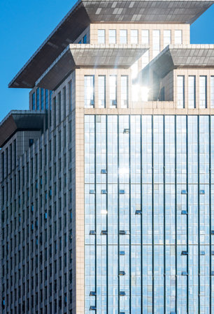 A beautiful background of an glass office building, reflecting clouds in the opened windowsのeditorial素材