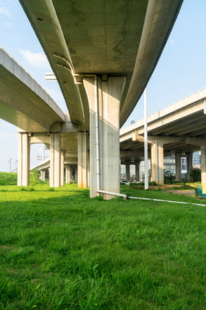 Concrete structure and asphalt road space under the overpass in the cityの写真素材