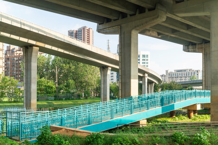 Concrete structure and asphalt road space under the overpass in the cityの写真素材
