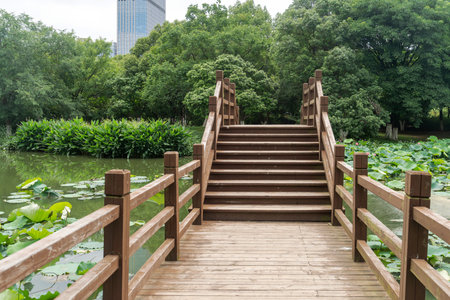 Wooden bridge over little river in city parkの写真素材