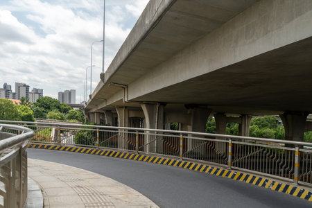 Concrete structure and asphalt road space under the overpass in the cityの写真素材