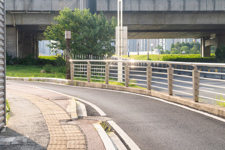Concrete structure and asphalt road space under the overpass in the cityの写真素材