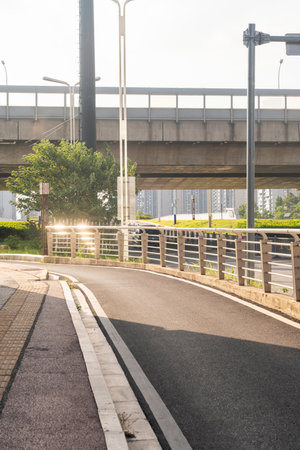 Concrete structure and asphalt road space under the overpass in the cityの写真素材