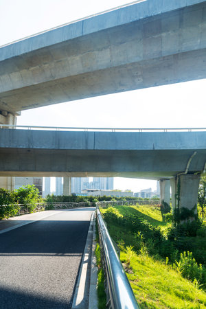 Concrete structure and asphalt road space under the overpass in the city