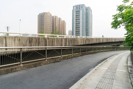 Concrete structure and asphalt road space under the overpass in the city