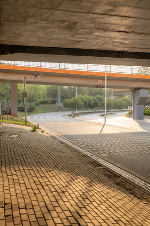 Concrete structure and asphalt road space under the overpass in the cityの写真素材