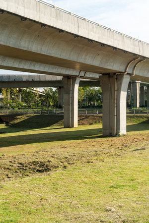 Concrete structure and asphalt road space under the overpass in the cityの写真素材
