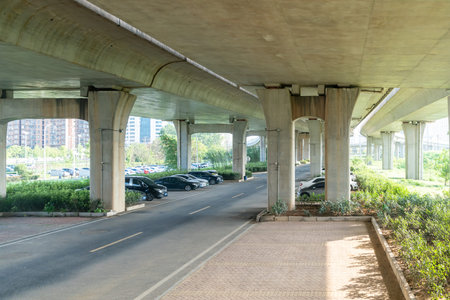 Concrete structure and asphalt road space under the overpass in the city