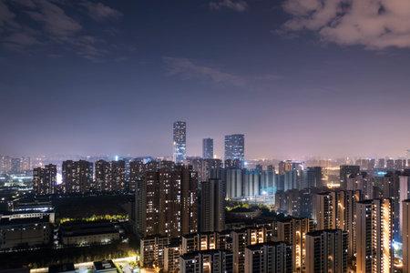 Bird view at Nanchang China. Skyscraper under construction in foreground. Fog, overcast sky and...