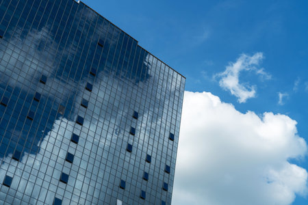 Clouds reflected in windows of modern office building