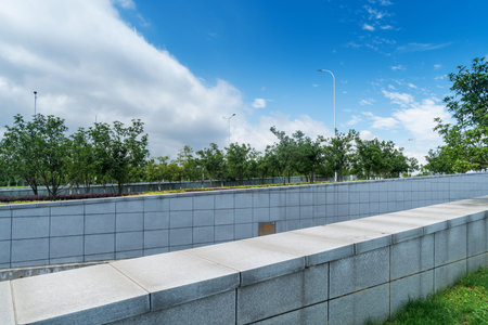 The park wall under the blue sky and white clouds