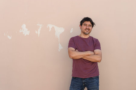 Latino man standing on wall