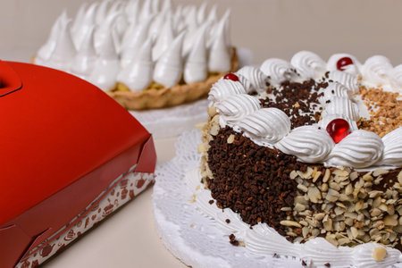 Cake in the foreground with box to add logo or brand. Graphic resource