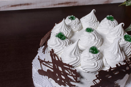 Close-up of cake with cream and decoration on green