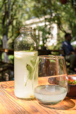 Small bottle and glass of lemonade, mint and gingerの写真素材