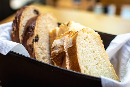 Slices of white, black and wholemeal bread served on a tray