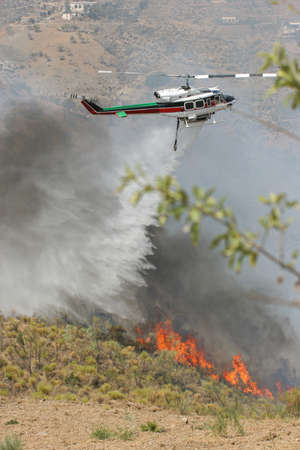 firefighters work in a fire helicopterの写真素材