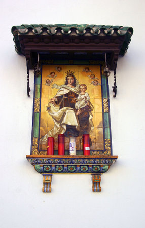 Detail of an altar with the Virgin on the facade of a houseの写真素材
